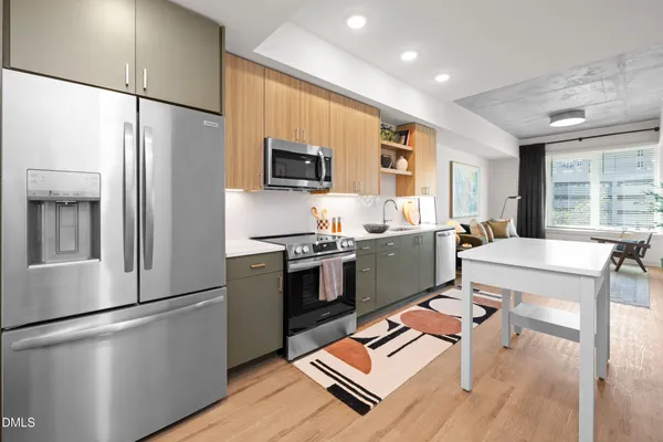 a kitchen with stainless steel appliances a refrigerator and a stove top oven