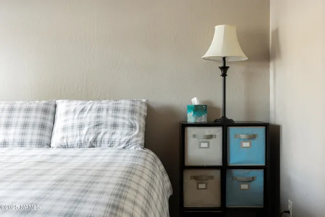 a bedroom with a bed and a lamp on table