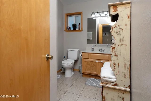 a bathroom with a toilet and a mirror
