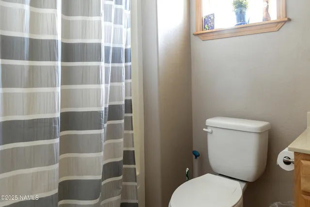 a white toilet sitting next to a bathroom sink