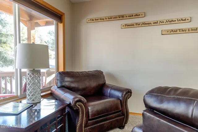 a view of a hallway with furniture and a window