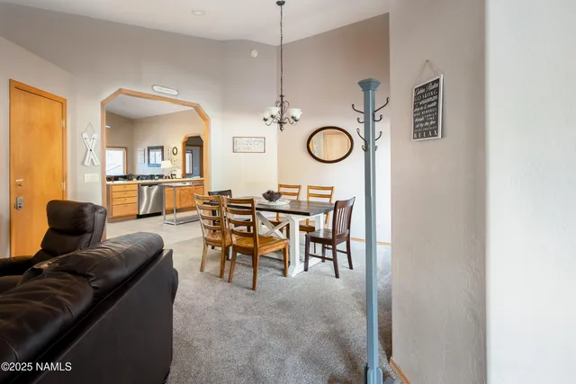 a living room with furniture a clock and a window