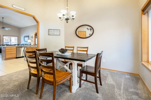 a dining room with furniture a chandelier and a rug