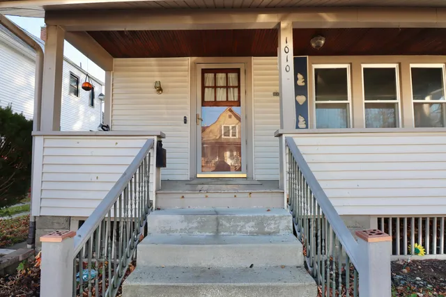 a view of entrance of house with stairs