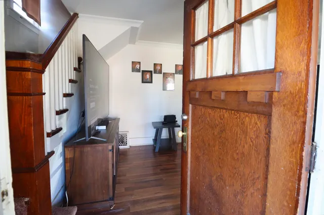 a view of living room with furniture and wooden floor