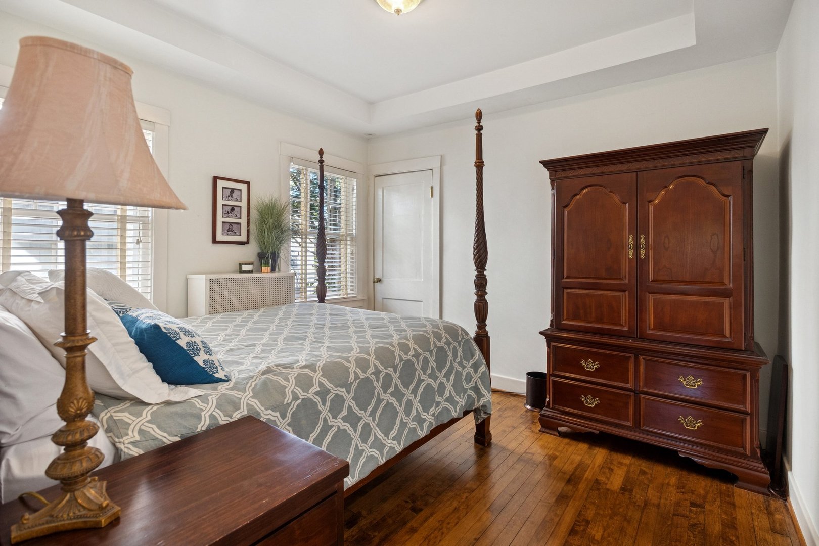 228 Poplar Street Winnetka, IL 60093 - Photo 13 of 34 a bedroom with a bed and wooden floor