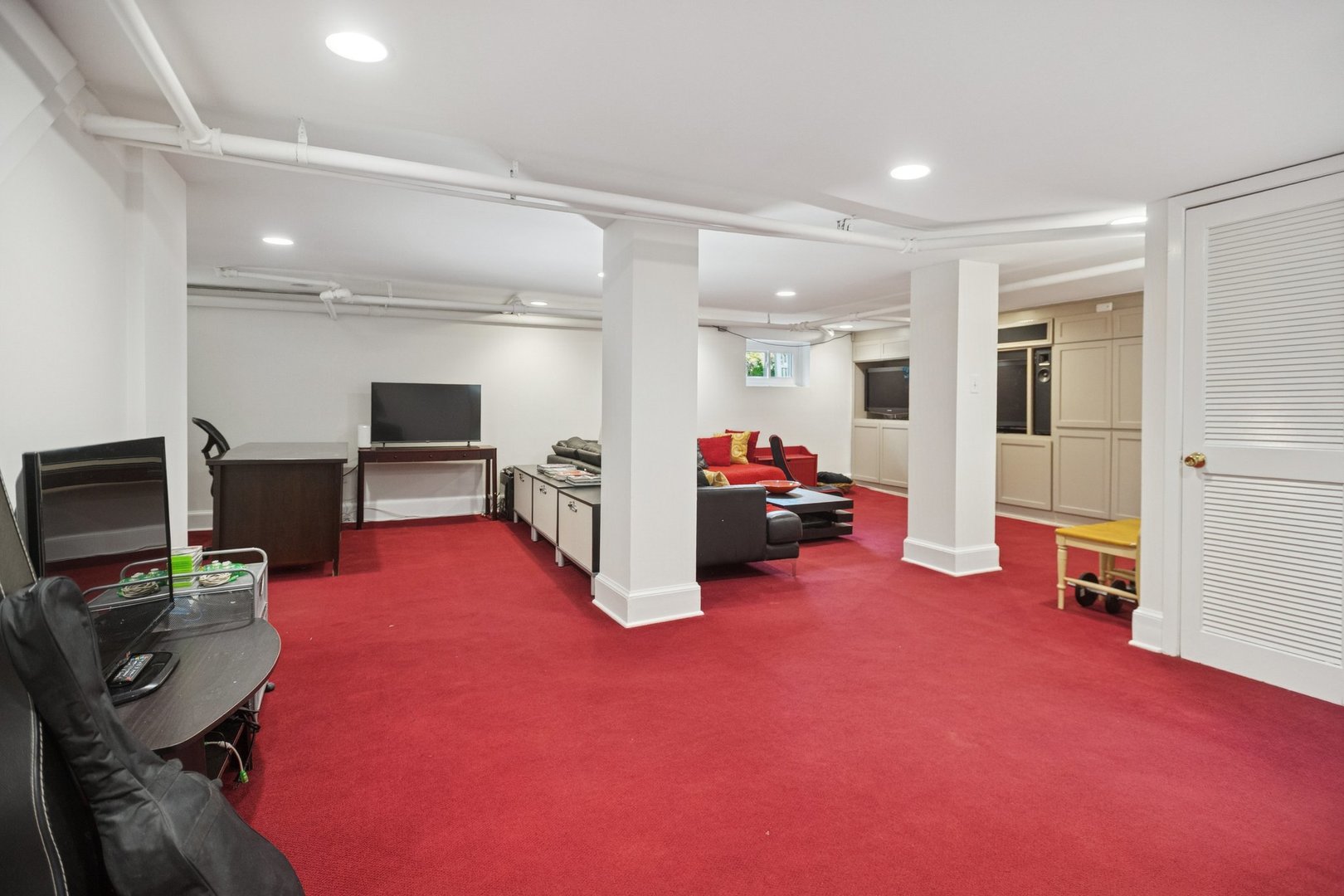 228 Poplar Street Winnetka, IL 60093 - Photo 23 of 34 a living room with furniture a flat screen tv and a refrigerator