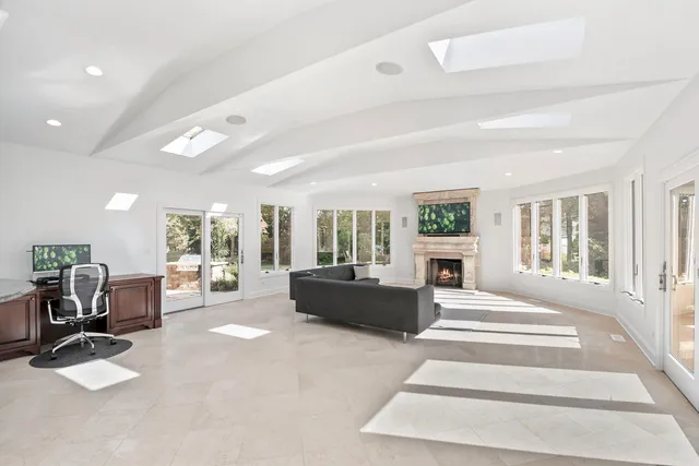 a bathroom with a granite countertop sink a toilet a mirror and shower