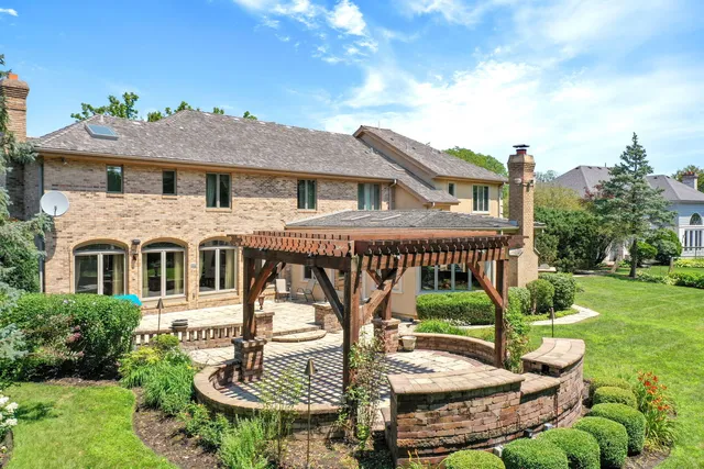 a front view of a house with a yard and potted plants
