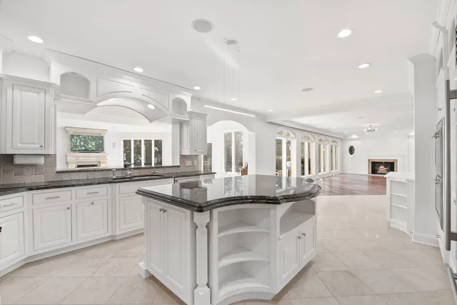 an aerial view of residential house with outdoor space and trees all around