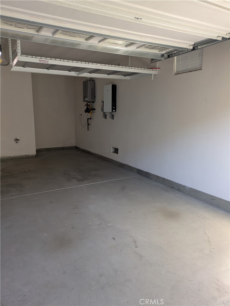 42945 Avenida Amistad Temecula, CA 92592 - Photo 28 of 32 Garage has overhead storage racks and instant hot water heater