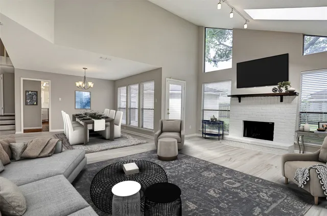 a living room with furniture a flat screen tv and a fireplace