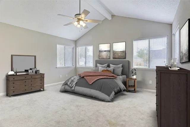 a spacious bedroom with a bed and window