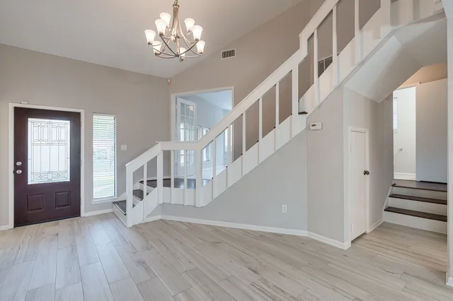 a view of entryway and hall with wooden floor