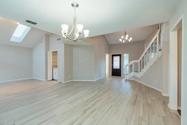 a view of a livingroom with wooden floor and a ceiling fan