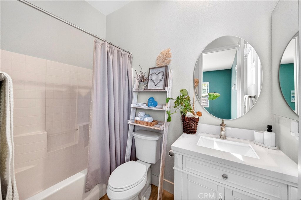 16375 Ory Circle Riverside, CA 92503 - Photo 32 of 51 a bathroom with a sink a toilet and shower curtain