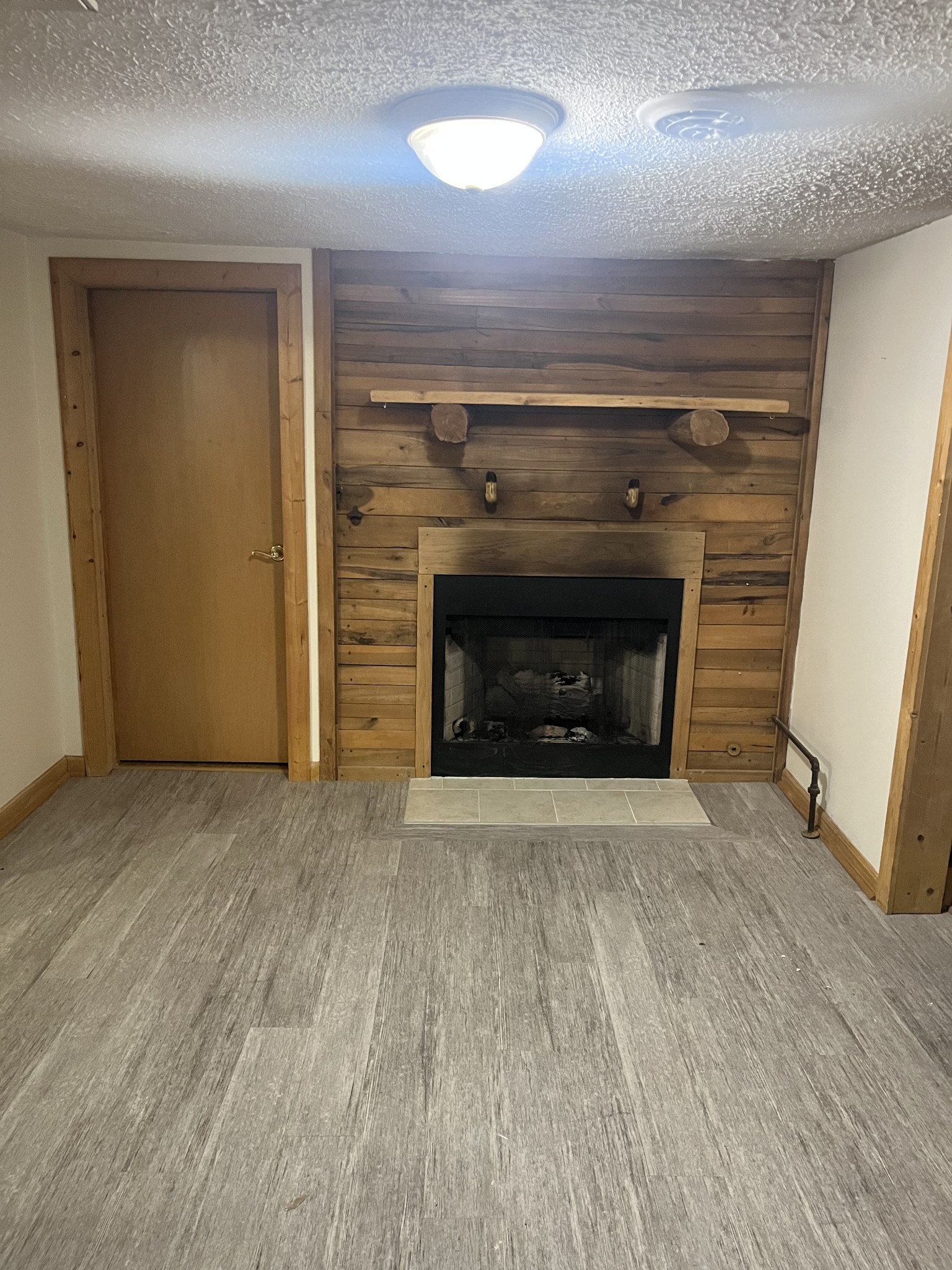 535 Gladeville Road Mount Juliet, TN 37122 - Photo 8 of 24 an empty room with wooden floor a fireplace and window