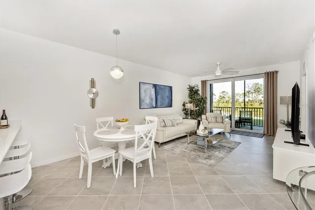 a view of a room that has a bed and glass door