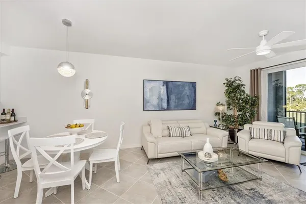 a living room with furniture and a chandelier