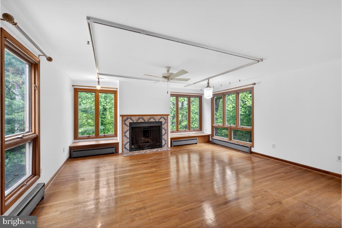 4068 Adams Drive Silver Spring, MD 20902 - Photo 27 of 43 a view of an empty room with a fireplace and a window