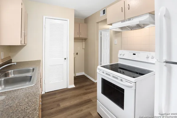 a kitchen with a stove and a sink
