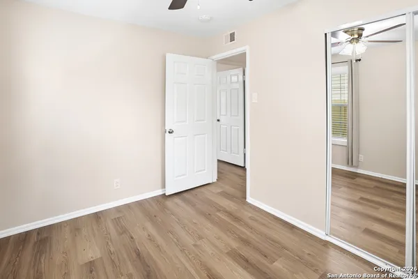 a view of a hallway with wooden floor