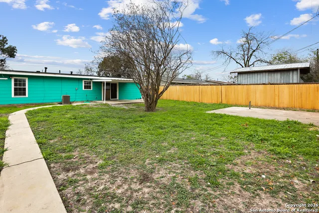 a view of backyard with swimming pool