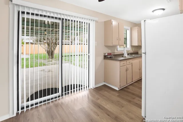 a kitchen with stainless steel appliances granite countertop a stove a sink and a window
