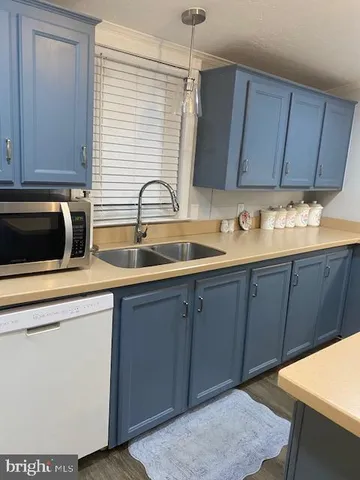 a kitchen with a sink cabinets and appliances