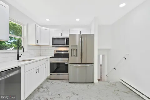 a kitchen with a sink stainless steel appliances and cabinets