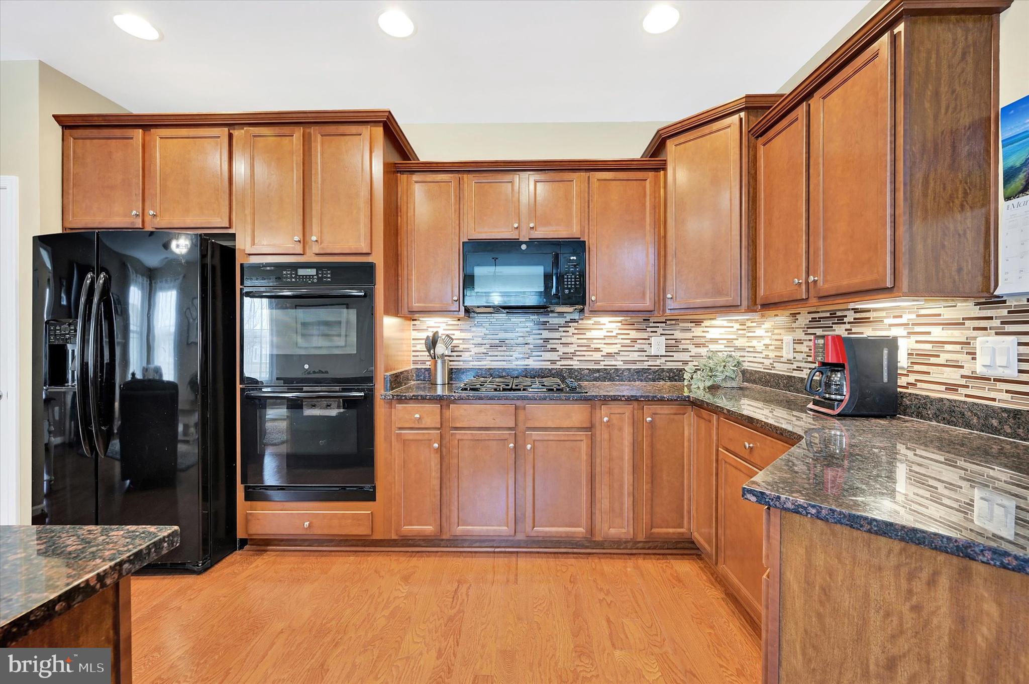 48 Canvasback Circle Bridgeville, DE 19933 - Photo 13 of 44 a kitchen with stainless steel appliances granite countertop a refrigerator sink and cabinets