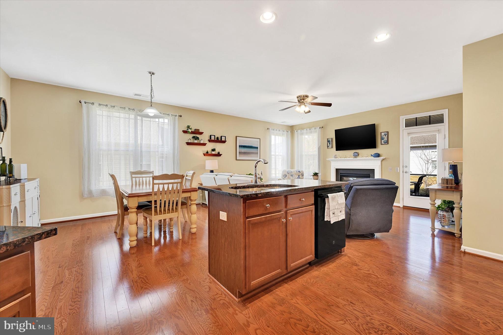 48 Canvasback Circle Bridgeville, DE 19933 - Photo 15 of 44 a living room with stainless steel appliances kitchen island granite countertop a table chairs and a refrigerator