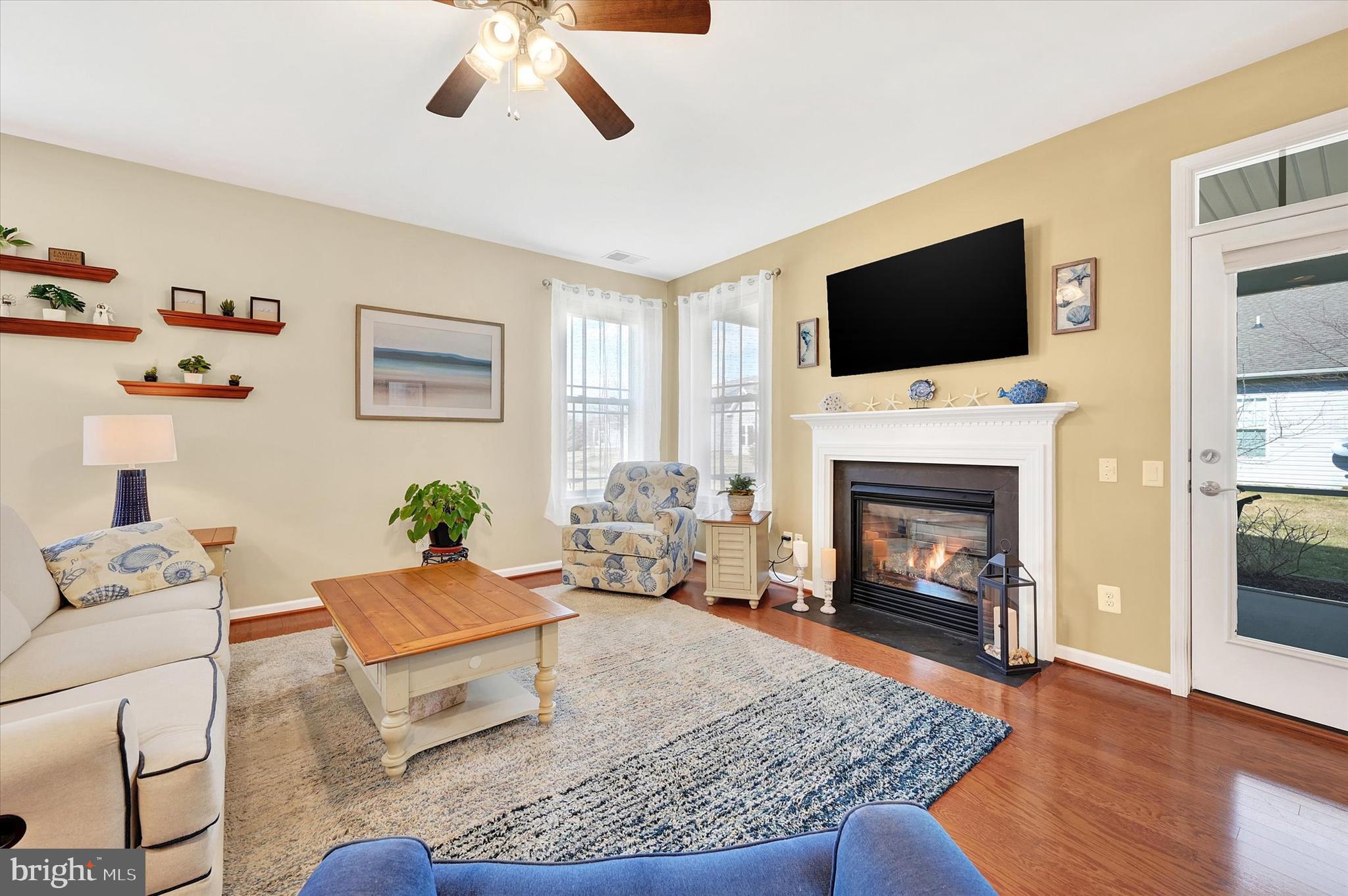 48 Canvasback Circle Bridgeville, DE 19933 - Photo 16 of 44 a living room with furniture a flat screen tv and a fireplace