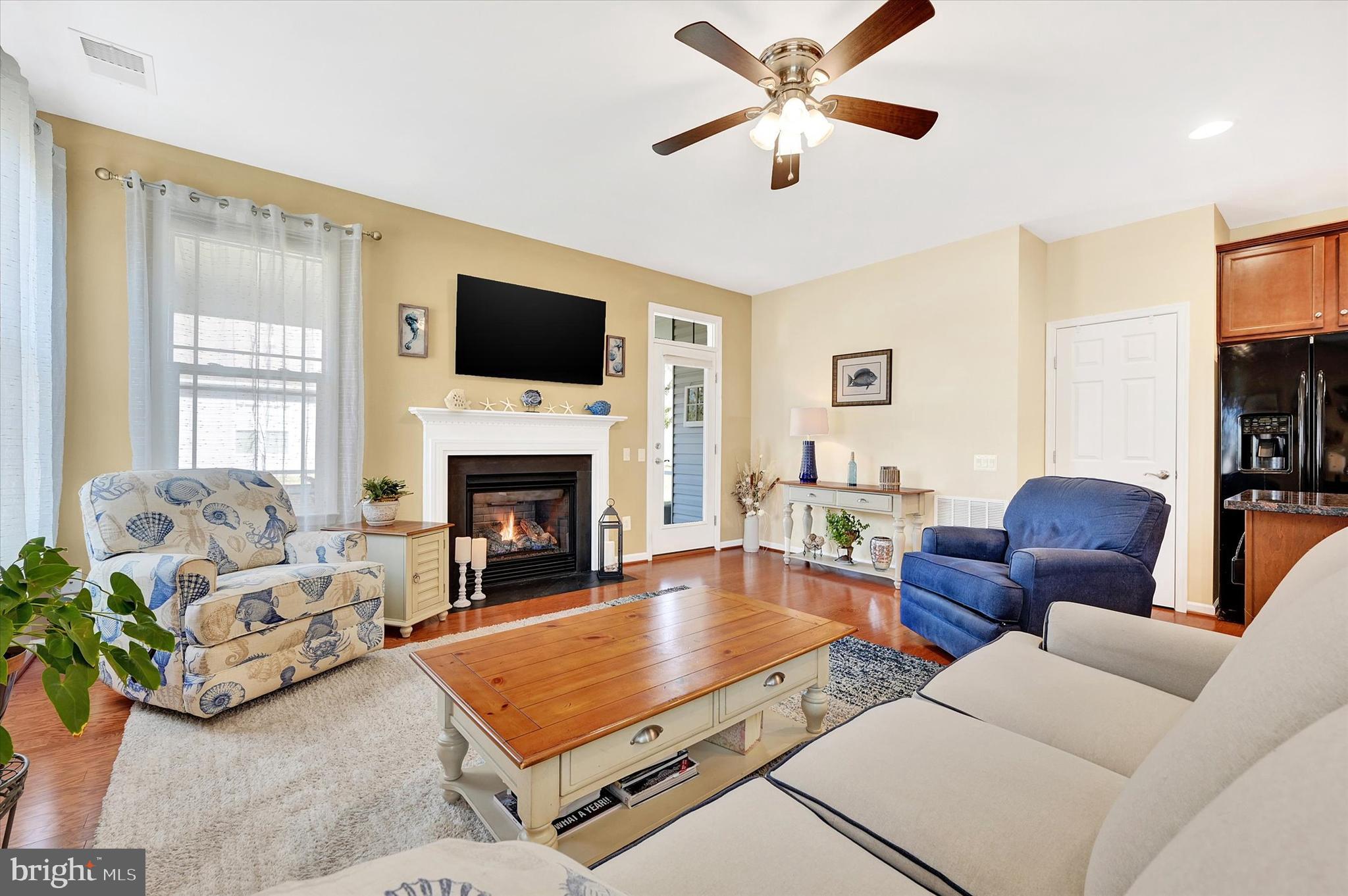 48 Canvasback Circle Bridgeville, DE 19933 - Photo 17 of 44 a living room with furniture a flat screen tv and a fireplace
