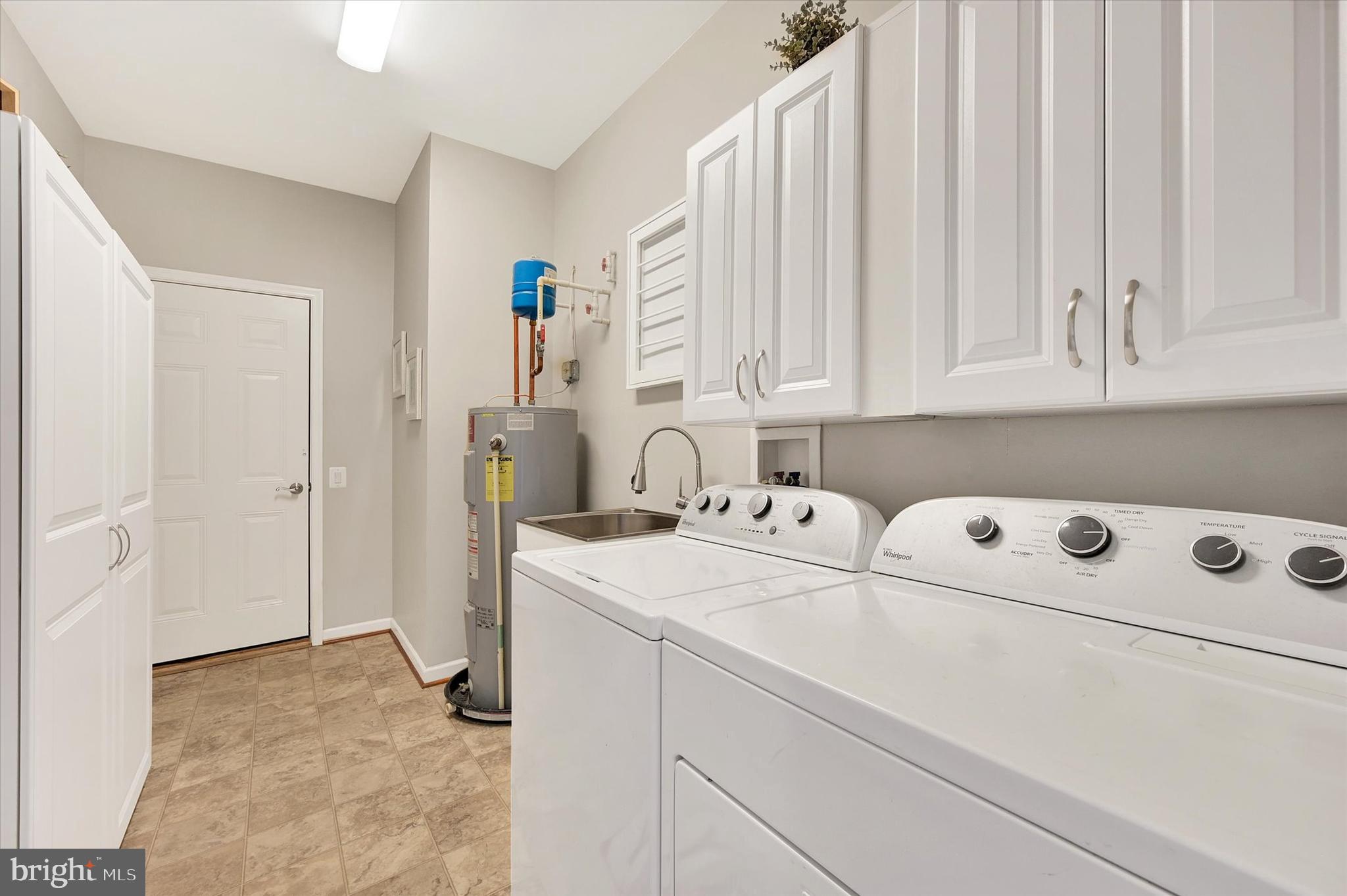 48 Canvasback Circle Bridgeville, DE 19933 - Photo 27 of 44 a view of washer and dryer with kitchen in the background