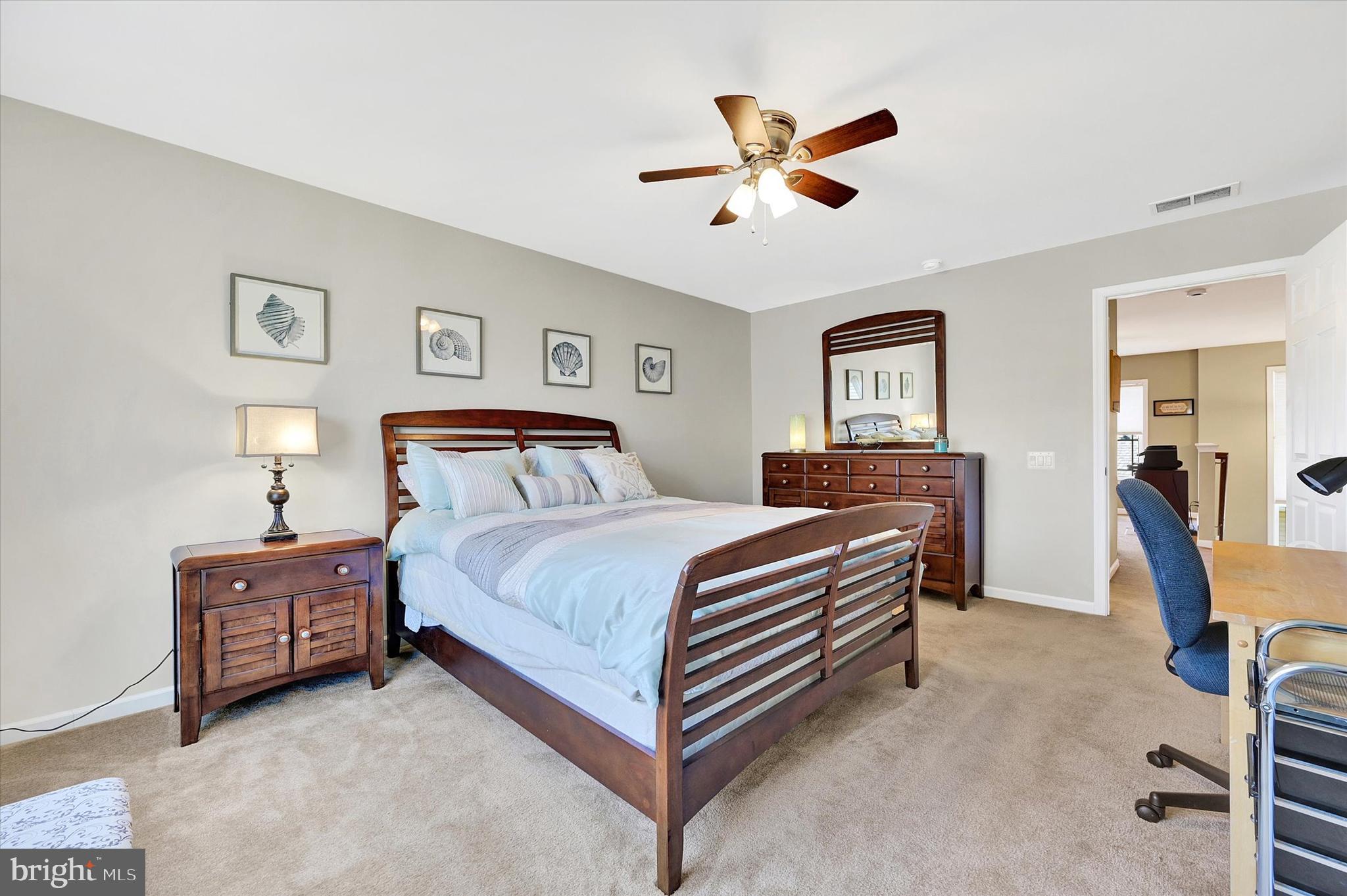 48 Canvasback Circle Bridgeville, DE 19933 - Photo 33 of 44 a bedroom with a bed and a chandelier