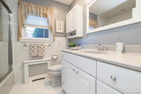 a bathroom with a sink a toilet and a mirror