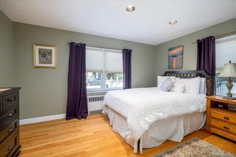 a spacious bedroom with a bed and a window