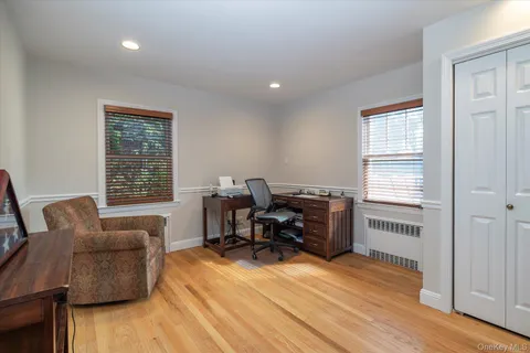 a livingroom with workspace and a window