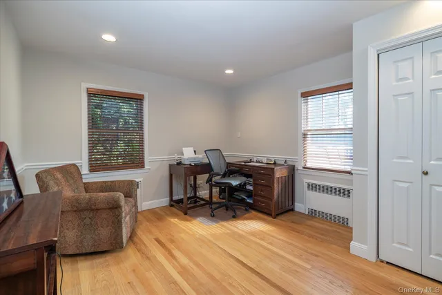 a livingroom with workspace and a window