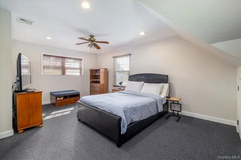 a spacious bedroom with a bed and a couch