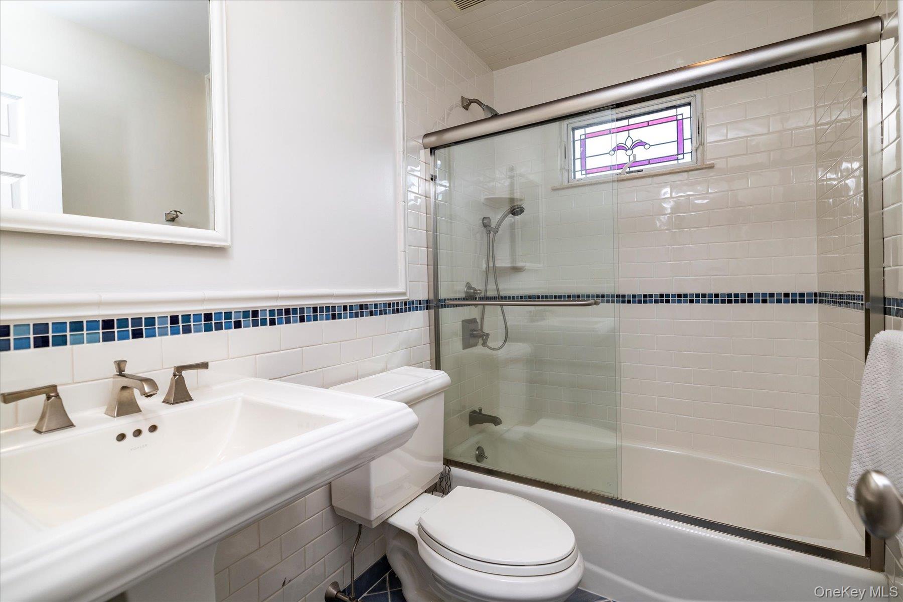 122 Pine Street Rockville Centre, NY 11570 - Photo 21 of 27 a bathroom with a sink mirror toilet and shower