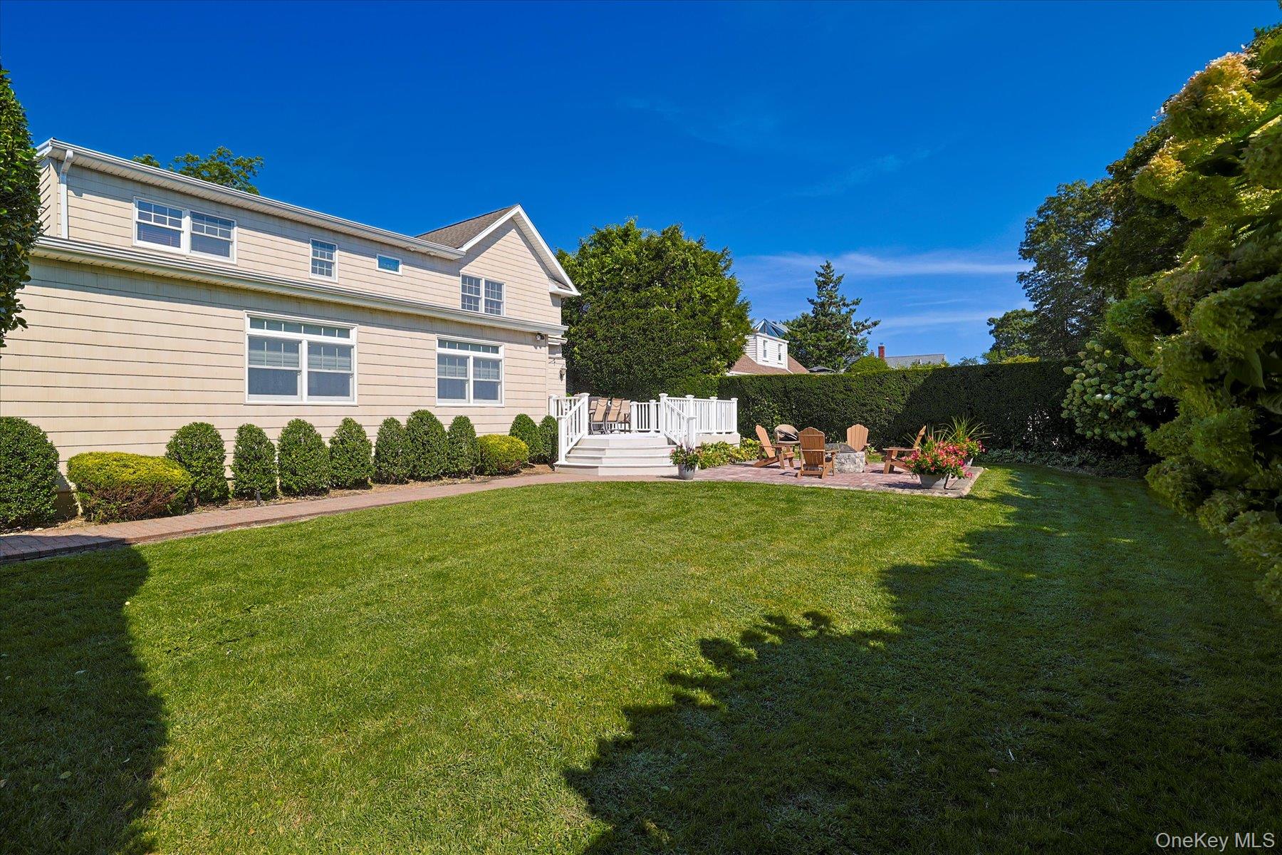 122 Pine Street Rockville Centre, NY 11570 - Photo 3 of 27 a front view of a house with garden