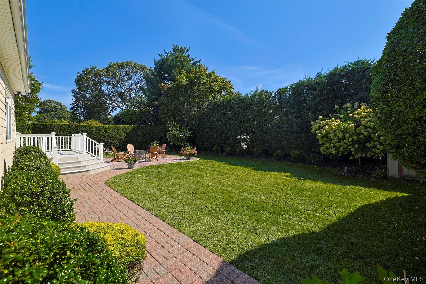 122 Pine Street Rockville Centre, NY 11570 - Photo 4 of 27 a view of a garden with lawn chairs