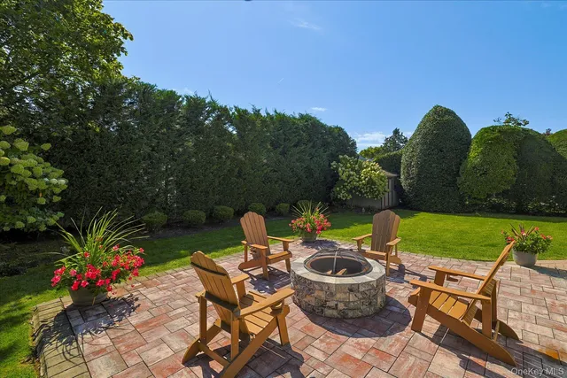 a view of a backyard with sitting area and garden