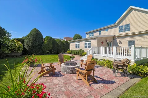 a view of a house with backyard sitting area and garden