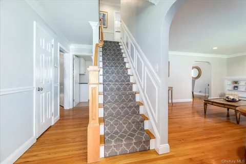 a view of entryway and hall with wooden floor
