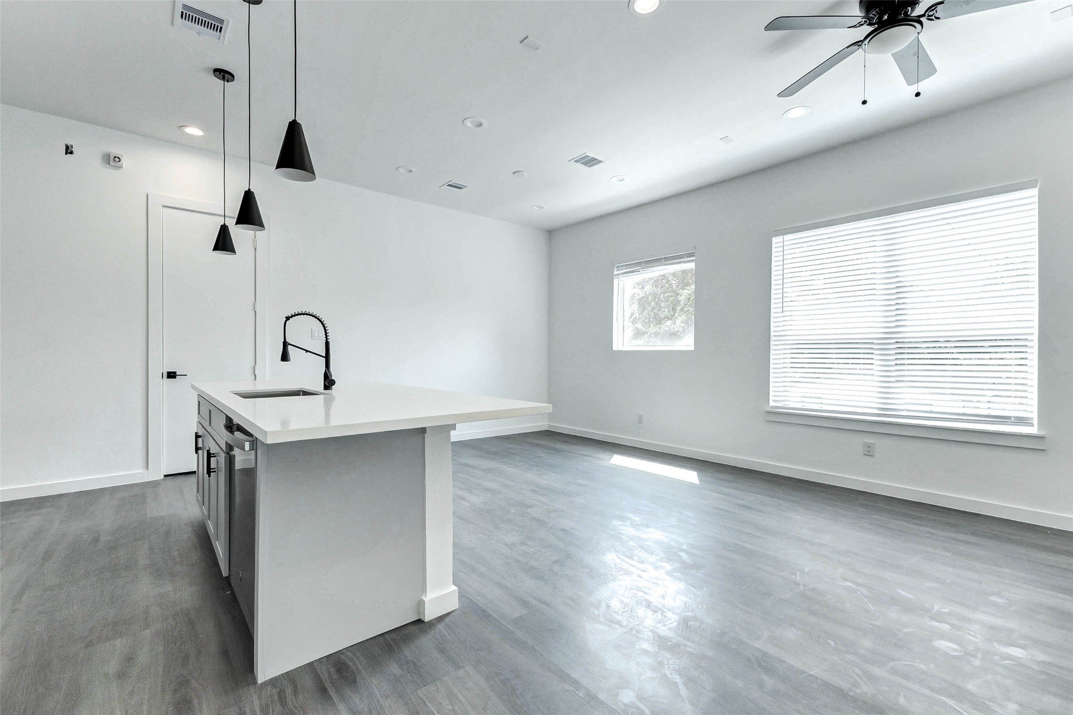 6013 Beall Street Houston, TX 77091 - Photo 8 of 26 A dream kitchen for modern living featuring an oversized quartz island, matte black pendant lights, Energy Star appliances, and effortless flow into the sunlit living space.