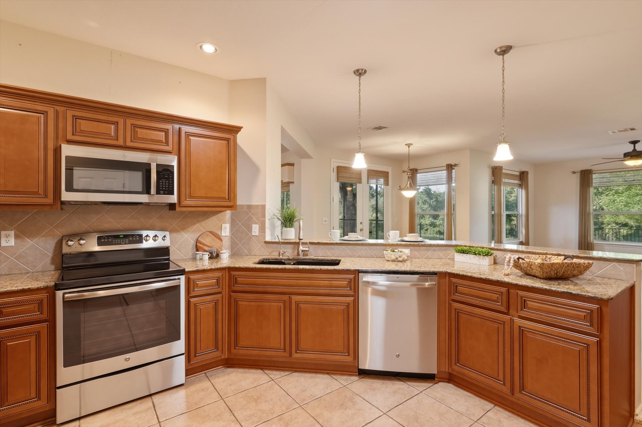 126 Trail Rider Way Georgetown, TX 78633 - Photo 11 of 30 a kitchen with a sink stove and microwave