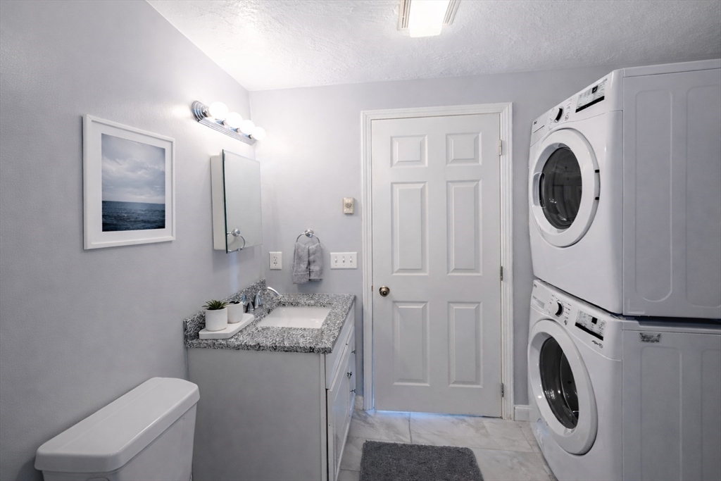 7 Gibbs Street, Unit 7 Worcester, MA 01607 - Photo 3 of 20 a bathroom with a sink mirror and toilet